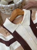 Eatures functional front buttons, a tailored polo collar, and ribbed elastic cuffs designed to trap heat and block out winter chills.