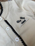 Fabric: Premium Soft Acrylic-Cotton Blend (Completely itch-free and gentle on skin)Items Included: Scallop-Edge Button Cardigan, Matching Black Knit Trousers