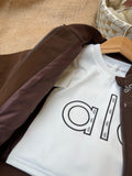 Rich Chocolate Brown / Earthy Espresso Premium smooth utility bomber jacket featuring elegant "alo" monogram luxury patterns on the front panels and collar.